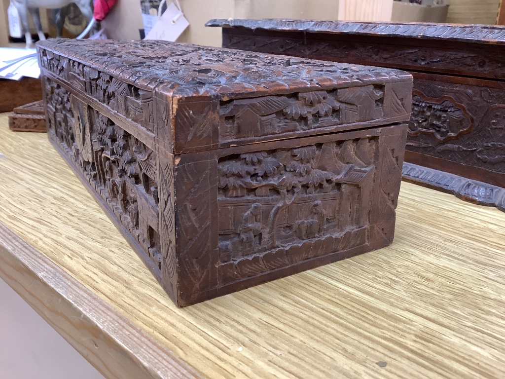 Two 19th century Chinese carved sandalwood boxes, together with a similar puzzle box, length 27cm